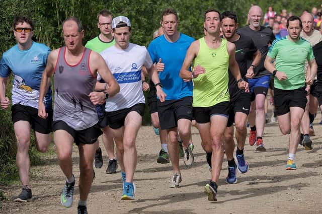 Scarborough Athletic Club's Daniel Bateson, lime vest, wins at North Yorkshire Water Park parkrun