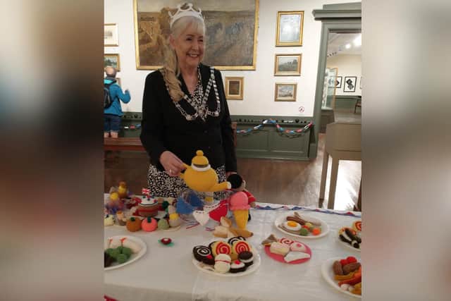 Mayor of Whitby, Cllr Linda Wild, with the Knitted Street Party, showing at Whitby's Pannett Art Gallery.