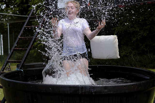 Olivia Lunn takes the plunge at the Snainton Jubilee party's Young Farmers splash challenge. Photo: Richard Ponter