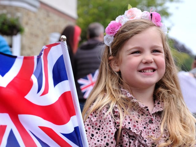 Poppy waves a flag to celebrate the Queen in Scalby.