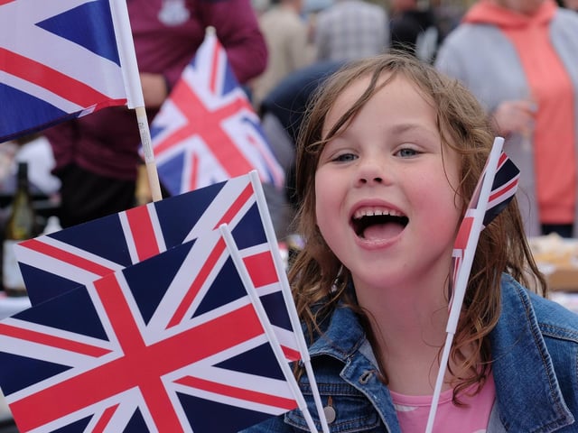 Rinnie enjoying waving multiple flags for Her Majesty the Queen in Scalby.