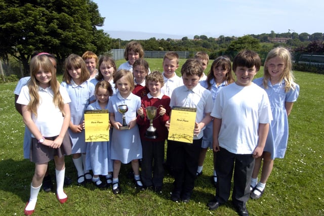 St Hilda's RC Primary School Choir wins first place. Pupils are pictured with their trophies and certificates.