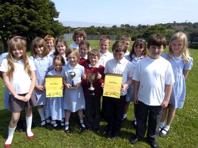 St Hilda's RC Primary School Choir wins first place. Pupils are pictured with their trophies and certificates.