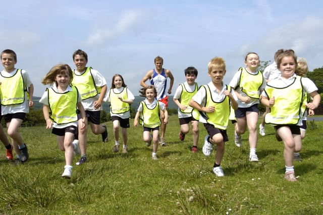 Children from Goathland Primary School run in the village with Alec Duffield from Loftus and Whitby Athletics Club.