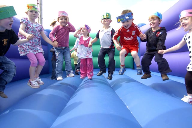 Young pupils from Oakridge Primary School enjoy their summer party on a bouncy castle.