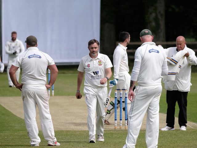 Visiting bowler Peter Kay walks back to his mark