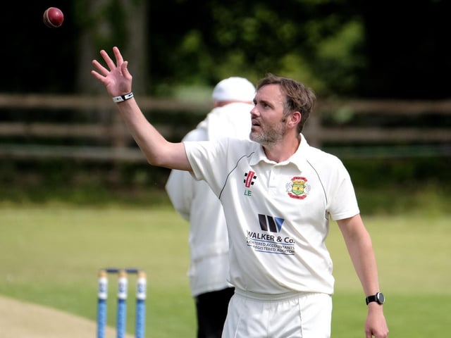 Folkton & Flixton 2nds bowler Peter Kay collects the ball before another delivery