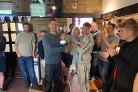 Julie and Mark Welford's son Robbie presents the Blacksmiths team with the trophy after veteran footballers raise £700 for British Heart Foundation in Mark & Julie Welford Memorial Trophy match.