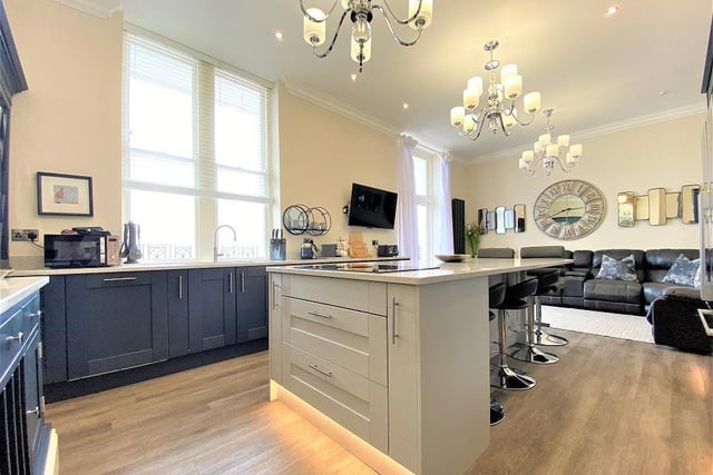 The central island with breakfast bar is a focal point of the open plan kitchen.