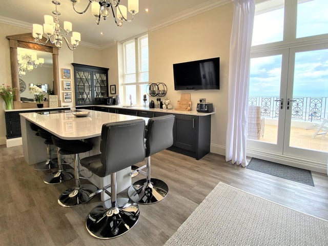 An alternative view of the kitchen with its doors out to the wide terrace.