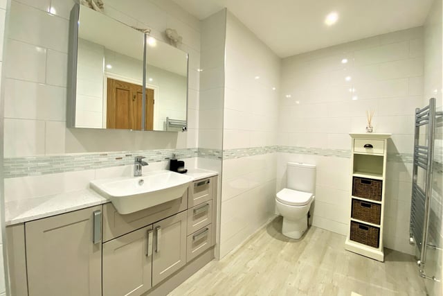 A built-in vanity unit is a feature of this apartment bathroom.