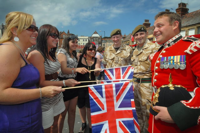 On Armed Forces Day in Scarborough the troops receive a welcome from, left to right, Lynn Walton, Vicki Turnbull, Tamlyn Cummings and Amanda Turnbull with Tony Smith, Alan Lanaway and Phil Moir.