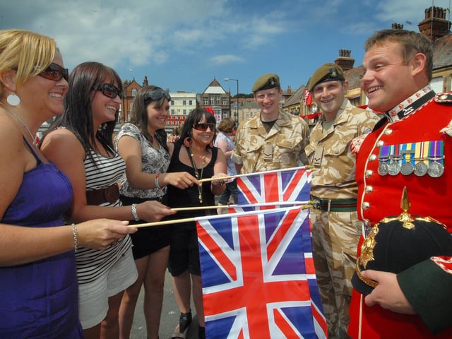 On Armed Forces Day in Scarborough the troops receive a welcome from, left to right, Lynn Walton, Vicki Turnbull, Tamlyn Cummings and Amanda Turnbull with Tony Smith, Alan Lanaway and Phil Moir.