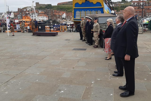 Members of Whitby Town Council and the Armed Forces watch the ceremony.