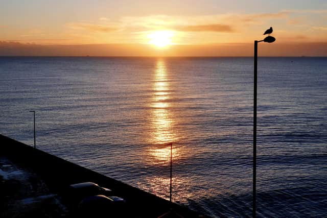 Aled Jones focuses on a classic sunrise above the waves to create this lovely photograph.