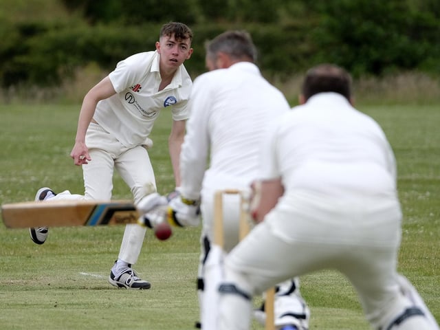 Jack Carradice-Clarkson of Flamborough bowls to Scarborough Rugby Club batter Paul Bond