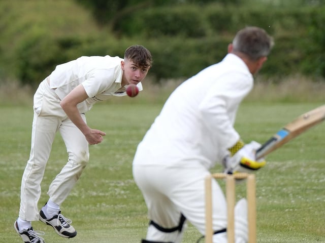 Jack Carradice-Clarkson of Flamborough bowls to Scarborough Rugby Club batter Paul Bond