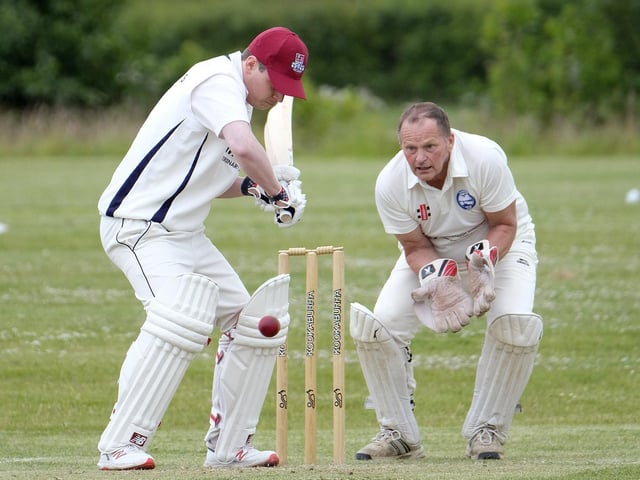 Scarborough Rugby Club batter Callum Norris is watched by Flamborough keeper Mark Abrams