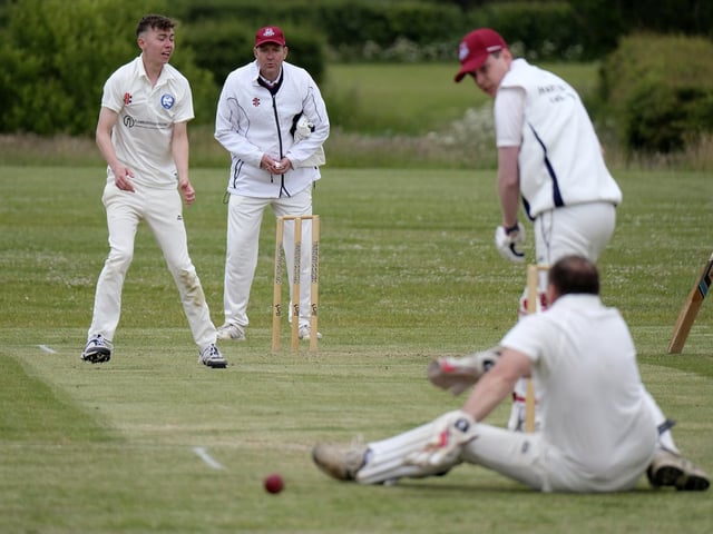 Jack Carradice-Clarkson of Flamborough bowls to Scarborough Rugby Club batsman Callum Norris