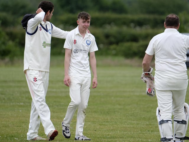 Jack Carradice-Clarkson of Flamborough is congratulated after dismissing Scarborough Rugby Club batter Paul Bond