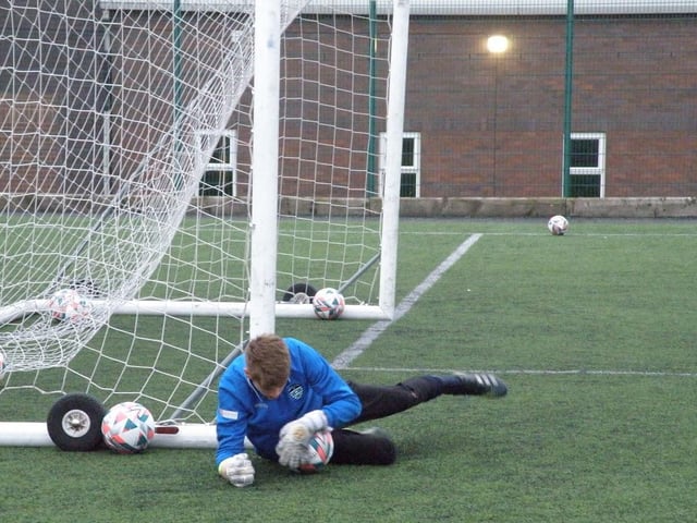 Young Whitby Town goalkeeper George Scaife makes a save