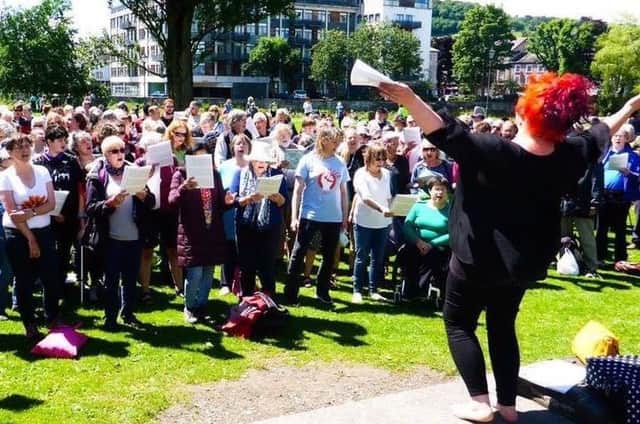 Rebecca Denniff leads a massed sing rehearsal at a previous street choir festival in Kendal