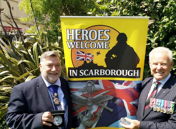Cllr Eric Broadbent, Mayor of the Borough of Scarborough (left) and John Senior MBE TD (right) with the commemorative coins