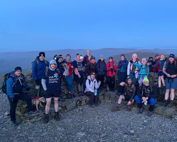 These walkers enjoy a spectacular mountain-top view of the sunset.