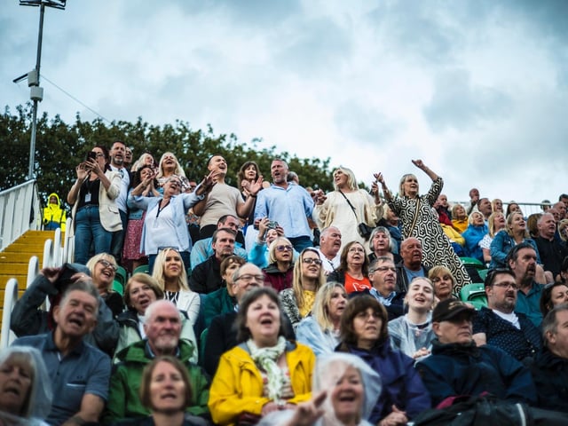 The crowd singing along to the hits