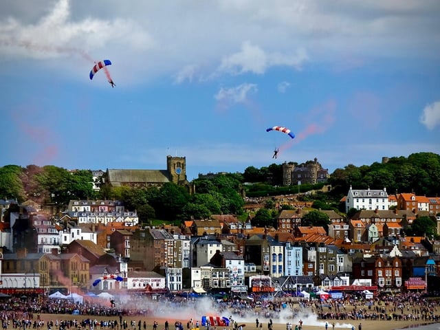 RAF Falcons over the old town of Scarborough before landing on Scarborough's South Bay Beach
