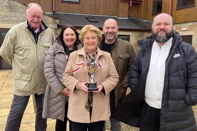 Boro chairman Trevor Bull (left) and Ant Taylor of the VBS Travel Club, present the Jeff Barmby memorial Cup to Jeff's daughter Debbie, wife Pat and son-in-law Mike.