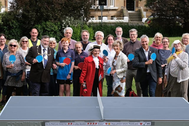 Everyone is ready for action at the official opening of the outdoor table tennis table in Prince of Wales Gardens
