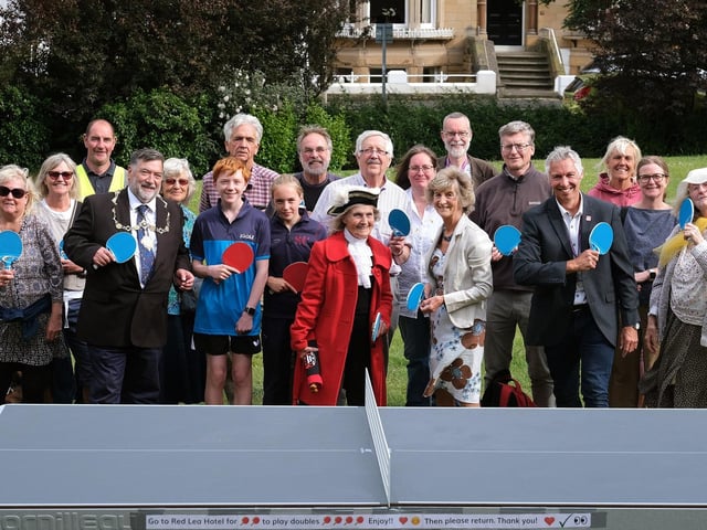 Everyone is ready for action at the official opening of the outdoor table tennis table in Prince of Wales Gardens
