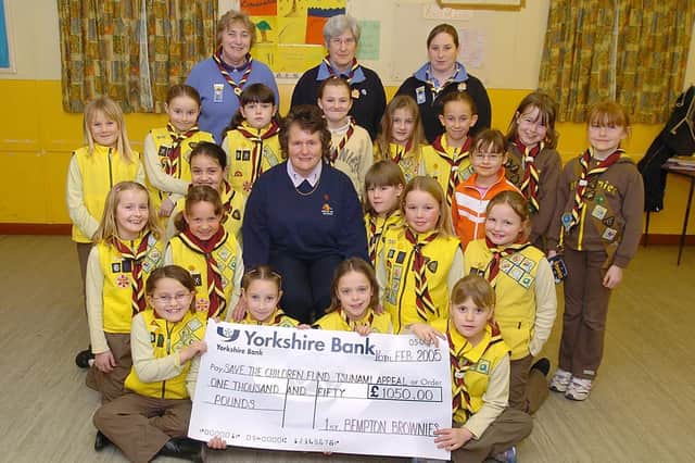 Bempton 1st Brownies group presents a cheque for £1,050 to Joan Towse in support of  the Save the Children Fund Tsunami Appeal in 2004. Do you recognise any of the people in the photograph, taken by Paul Atkinson. (PA0407-14)