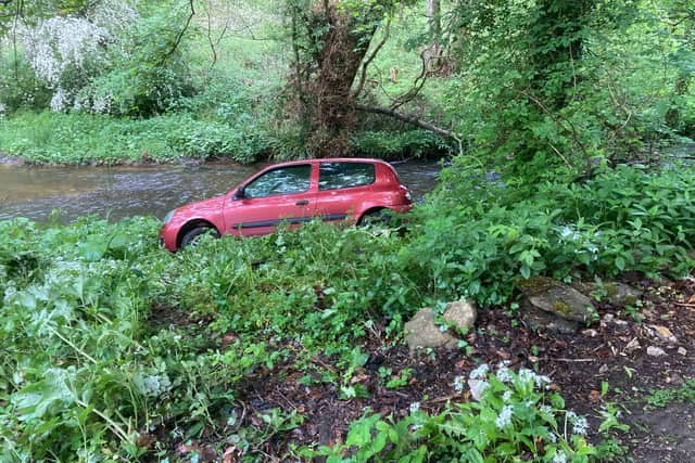 A car crashes down the bankside and almost ends up in the River Derwent. (Photo: Derek Rowell)