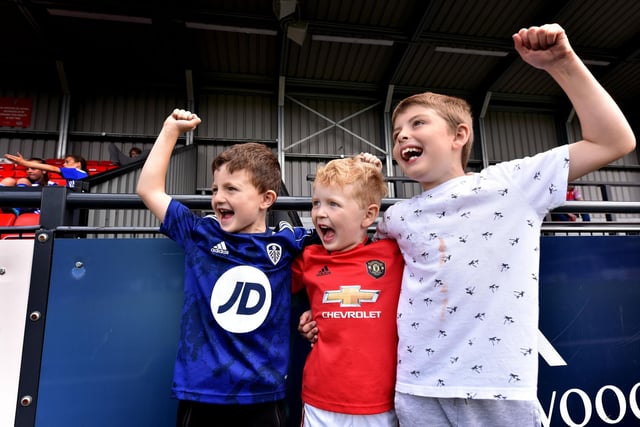 A trio of young supporters enjoy the football action