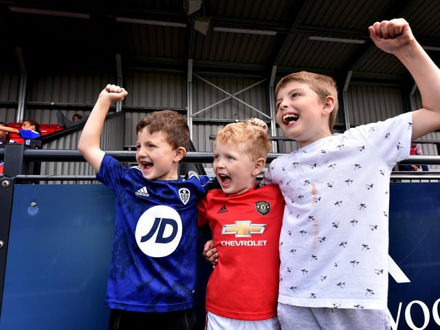 A trio of young supporters enjoy the football action