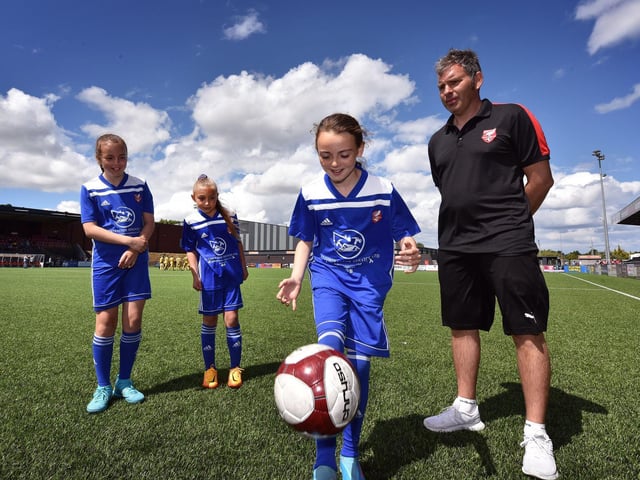 Scarborough Athletic's new girls footballers, Mia Morris Lila Exley and Lacey Mills are watched by Gary Hindle from the club. Photo by  Richard Ponter