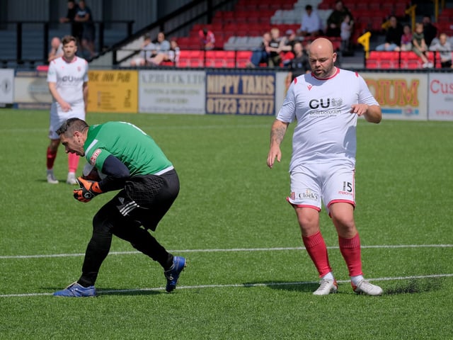 Scarborough FC Legends keeper Kevin Martin gathers the ball as Scarborough Athletic Legend Jimmy Beadle