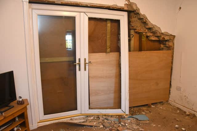 The car smashes through the front of the house and caused extensive damage.
