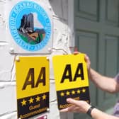 Andrew Jenkins installing new AA Five star signage at Orchard Lodge