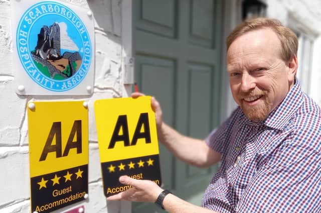 Andrew Jenkins installing new AA Five star signage at Orchard Lodge