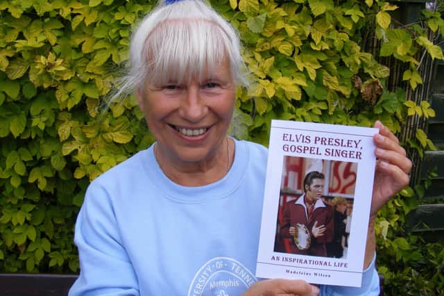 Madeleine Wilson is pictured with her book about Elvis Presley.