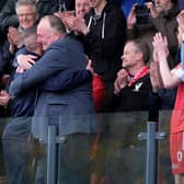 Boro chairman Trevor Bull hugs boss Jono Greening after their promotion to the National League North