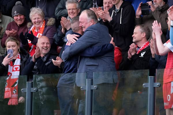 Boro chairman Trevor Bull hugs boss Jono Greening after their promotion to the National League North