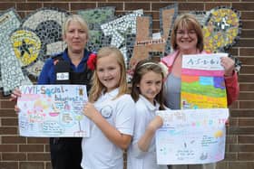 Flamborough School Children pose with their winning ASBO Posters in 2010.  Pictured with PCSO Beverley Feirn are Isobel Franshaw, 10, Siobhan Sutton, 10, and Dawn Wardell. Missing is Gina Hiest, 11, who won the competition. (PA1029-9)