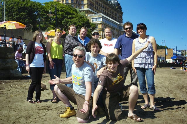 The Beached Committee gathers on the beach at South Bay before undertaking a site visit for a forthcoming concert.