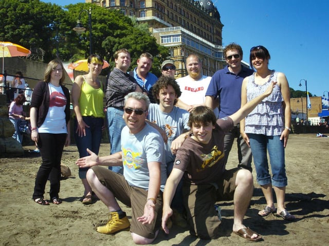 The Beached Committee gathers on the beach at South Bay before undertaking a site visit for a forthcoming concert.