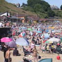 Beachgoers enjoy the sunshine and sea in Scarborough's North Bay.