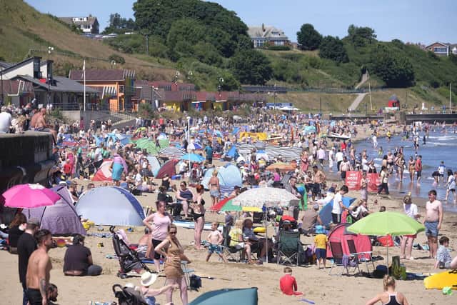 Beachgoers enjoy the sunshine and sea in Scarborough's North Bay.